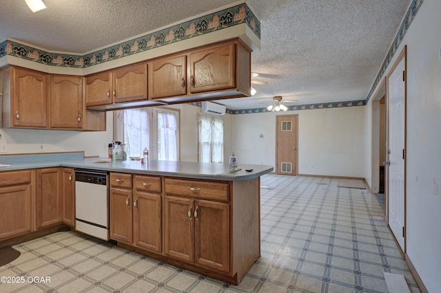 302 E Market St, Diamond, MO 64840 - kitchen with white dishwasher, a peninsula, a textured ceiling, and brown cabinets