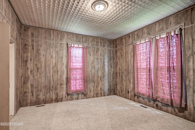 302 E Market St, Diamond, MO 64840 - empty room featuring wood walls and carpet floors
