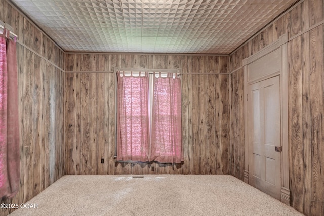 302 E Market St, Diamond, MO 64840 - empty room featuring wooden walls and carpet floors