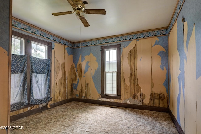 302 E Market St, Diamond, MO 64840 - carpeted empty room with healthy amount of natural light, a ceiling fan, and wallpapered walls