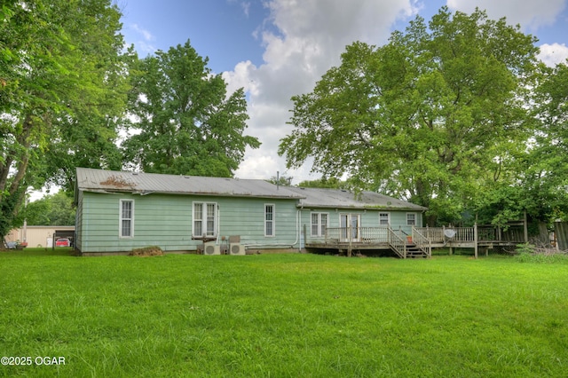 302 E Market St, Diamond, MO 64840 - rear view of property featuring a deck, a yard, and a metal roof