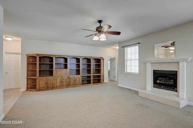 3024 N Chandler Ave, Joplin, MO 64801 - unfurnished living room featuring a ceiling fan, carpet flooring, and a tiled fireplace