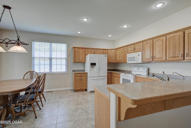 3024 N Chandler Ave, Joplin, MO 64801 - kitchen with white appliances, a kitchen breakfast bar, recessed lighting, a peninsula, and light countertops