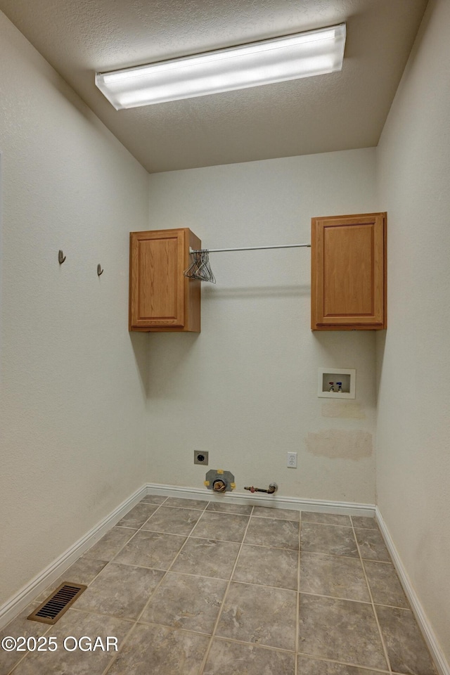 3024 N Chandler Ave, Joplin, MO 64801 - laundry room with hookup for a gas dryer, cabinet space, hookup for a washing machine, electric dryer hookup, and tile patterned flooring