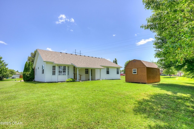 3024 N Chandler Ave, Joplin, MO 64801 - view of front of home featuring a storage shed, a front yard, and a shingled roof