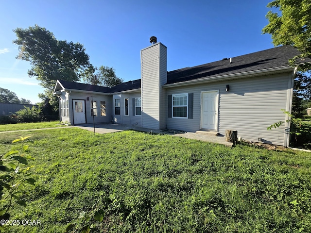 3511 Nola Dr, Joplin, MO 64801 - rear view of house featuring a patio, a chimney, and a lawn