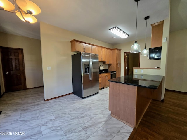 3511 Nola Dr, Joplin, MO 64801 - kitchen with stainless steel appliances, light marble finish floors, a peninsula, and hanging light fixtures