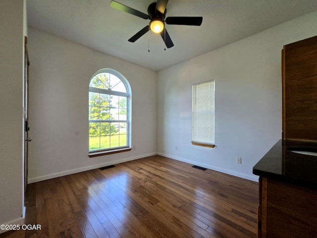 3511 Nola Dr, Joplin, MO 64801 - spare room featuring dark wood-type flooring and a ceiling fan