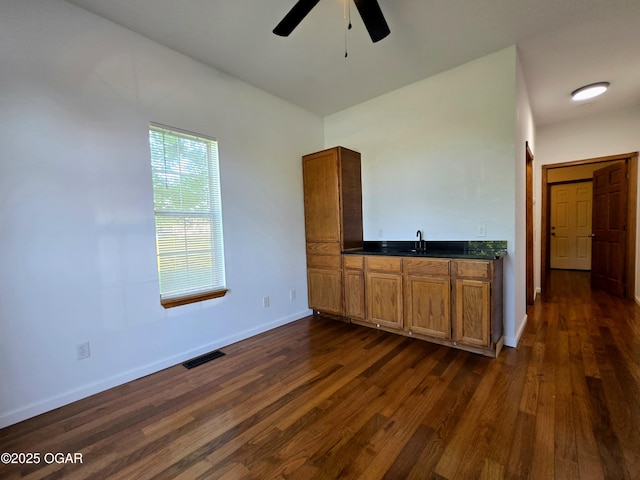 3511 Nola Dr, Joplin, MO 64801 - interior space with a ceiling fan, dark countertops, dark wood-style flooring, and brown cabinets