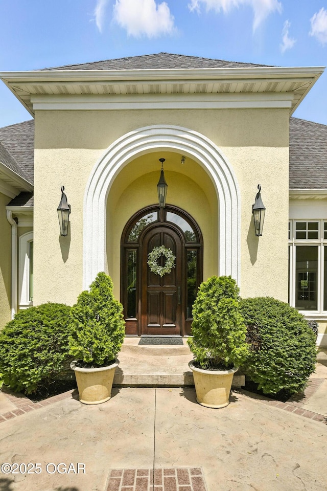5738 Deer Park Ln, Joplin, MO 64804 - view of exterior entry featuring stucco siding and a shingled roof