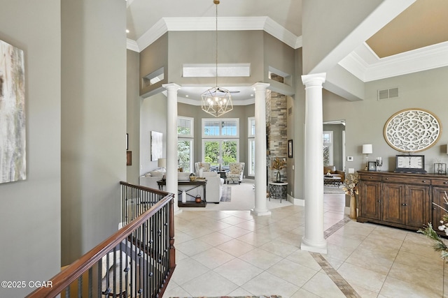 5738 Deer Park Ln, Joplin, MO 64804 - foyer entrance featuring decorative columns, a towering ceiling, crown molding, a chandelier, and light tile patterned floors