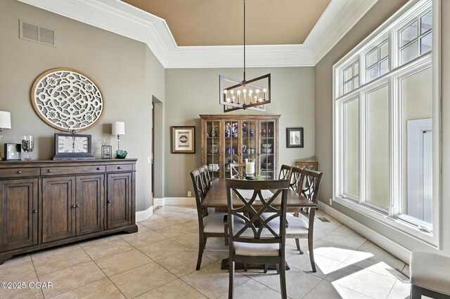 5738 Deer Park Ln, Joplin, MO 64804 - dining area with a towering ceiling, a chandelier, light tile patterned flooring, ornamental molding, and a raised ceiling