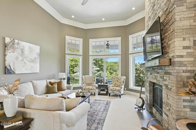 5738 Deer Park Ln, Joplin, MO 64804 - living area featuring healthy amount of natural light, a stone fireplace, carpet, a towering ceiling, and crown molding