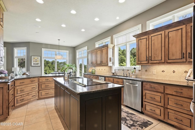5738 Deer Park Ln, Joplin, MO 64804 - kitchen featuring stainless steel dishwasher, recessed lighting, a kitchen island with sink, and plenty of natural light