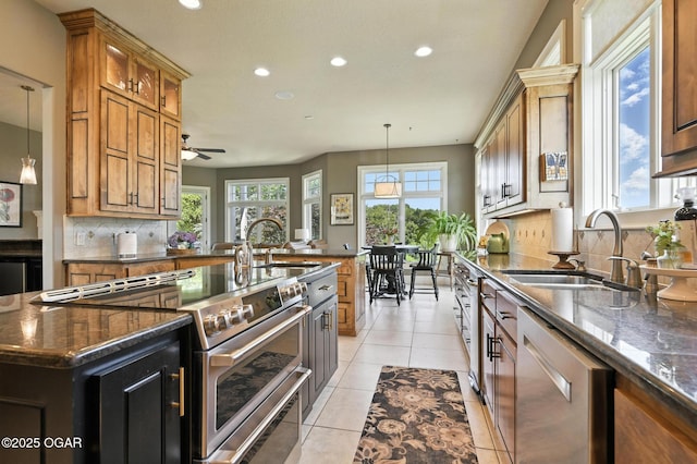 5738 Deer Park Ln, Joplin, MO 64804 - kitchen featuring appliances with stainless steel finishes, recessed lighting, backsplash, dark stone countertops, and hanging light fixtures
