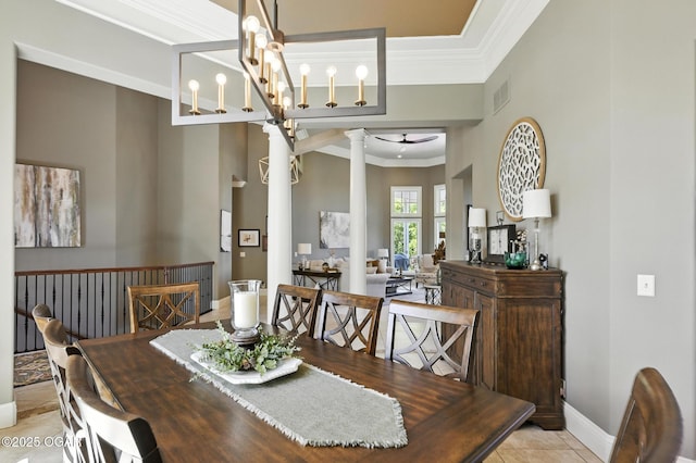 5738 Deer Park Ln, Joplin, MO 64804 - dining area with decorative columns, crown molding, a ceiling fan, and light tile patterned flooring
