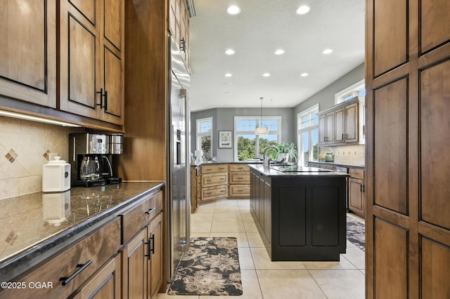 5738 Deer Park Ln, Joplin, MO 64804 - kitchen with recessed lighting, backsplash, an island with sink, light tile patterned floors, and pendant lighting