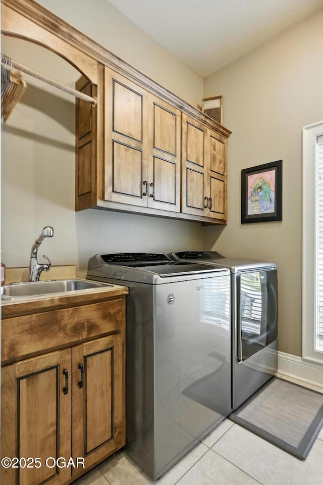 5738 Deer Park Ln, Joplin, MO 64804 - laundry room with washing machine and dryer, cabinet space, and light tile patterned floors