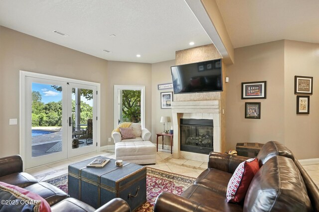 5738 Deer Park Ln, Joplin, MO 64804 - living room with light tile patterned floors, a fireplace, recessed lighting, and french doors