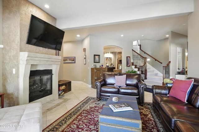 5738 Deer Park Ln, Joplin, MO 64804 - tiled living room featuring arched walkways, stairs, recessed lighting, and a premium fireplace