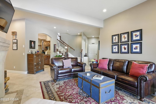 5738 Deer Park Ln, Joplin, MO 64804 - living room featuring arched walkways, stairway, light tile patterned flooring, and recessed lighting