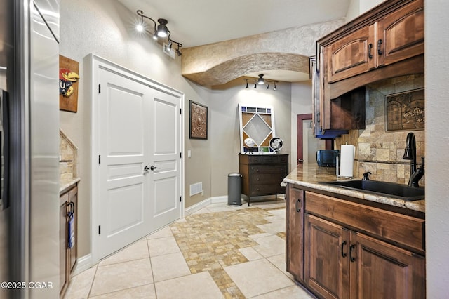 5738 Deer Park Ln, Joplin, MO 64804 - kitchen with fridge, tasteful backsplash, light countertops, and light tile patterned floors