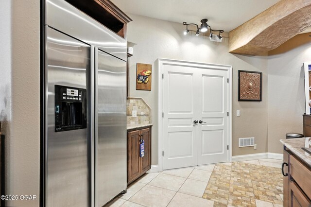 5738 Deer Park Ln, Joplin, MO 64804 - kitchen with built in refrigerator, light tile patterned flooring, and light stone counters