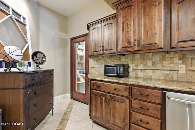 5738 Deer Park Ln, Joplin, MO 64804 - kitchen featuring black microwave, stainless steel dishwasher, inlaid floor details, backsplash, and light tile patterned floors