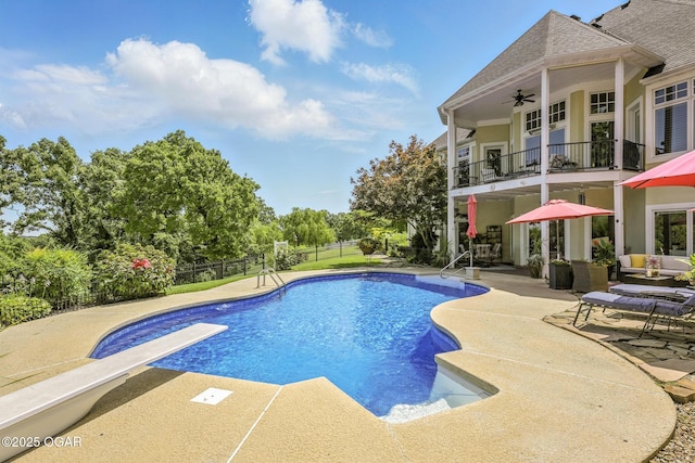 5738 Deer Park Ln, Joplin, MO 64804 - view of pool with a patio, a ceiling fan, a diving board, and view of wooded area