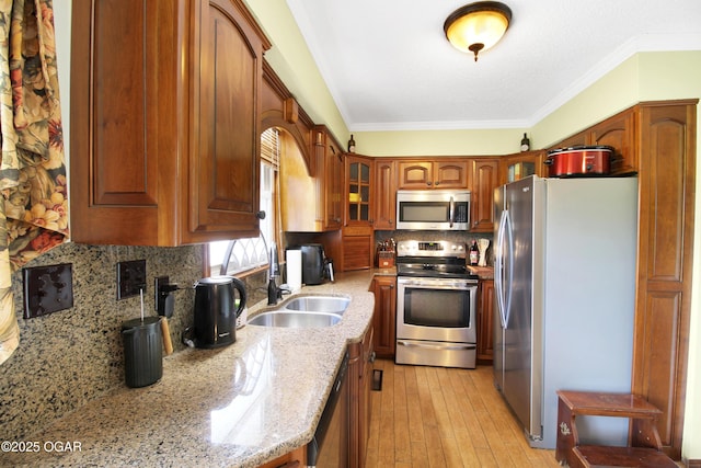 3508 Dirr Ave, Parsons, KS 67357 - kitchen featuring appliances with stainless steel finishes, light stone counters, glass insert cabinets, backsplash, and ornamental molding