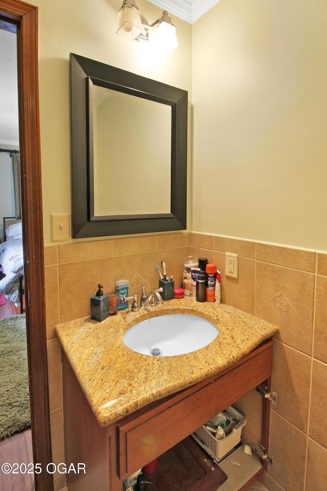 3508 Dirr Ave, Parsons, KS 67357 - bathroom with tile walls, vanity, crown molding, and wainscoting