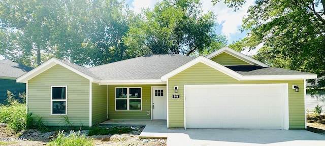 408 S Maple St, Carterville, MO 64835 - single story home with a garage, concrete driveway, and a shingled roof