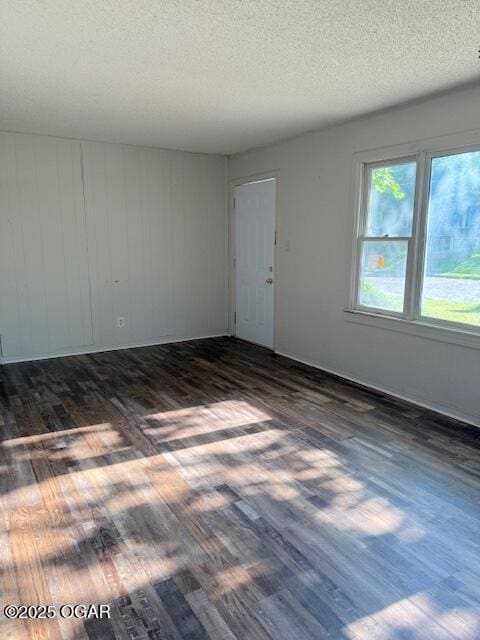 1705 S Walnut St, Pittsburg, KS 66762 - empty room featuring dark wood finished floors and a textured ceiling