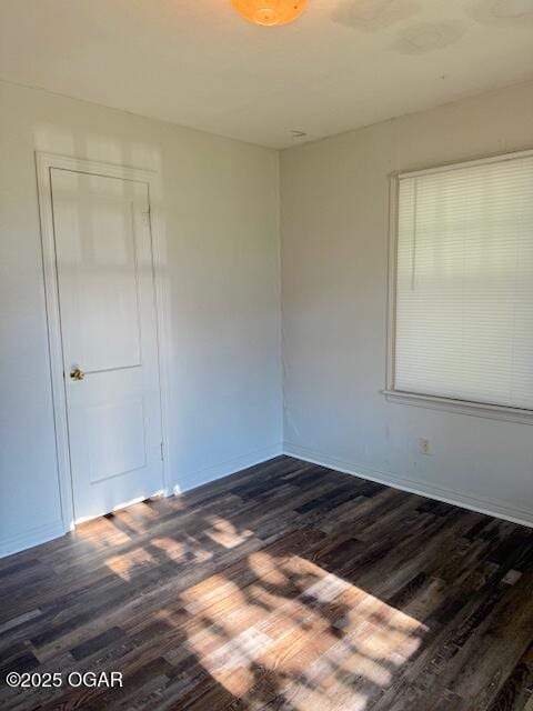1705 S Walnut St, Pittsburg, KS 66762 - empty room featuring dark wood finished floors and baseboards