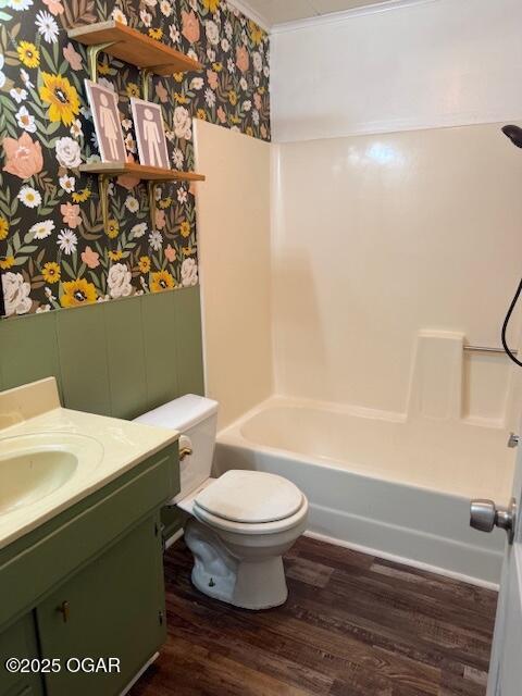 1705 S Walnut St, Pittsburg, KS 66762 - bathroom featuring wallpapered walls, wood finished floors, vanity,  shower combination, and ornamental molding