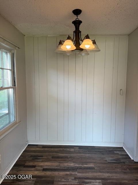 1705 S Walnut St, Pittsburg, KS 66762 - empty room with a textured ceiling, dark wood-style floors, and plenty of natural light