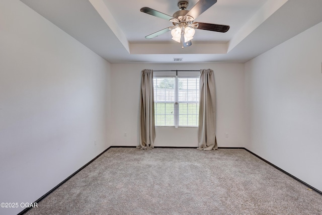 2036 S Ozark, Joplin, MO 64804 - spare room featuring a tray ceiling, ceiling fan, and carpet