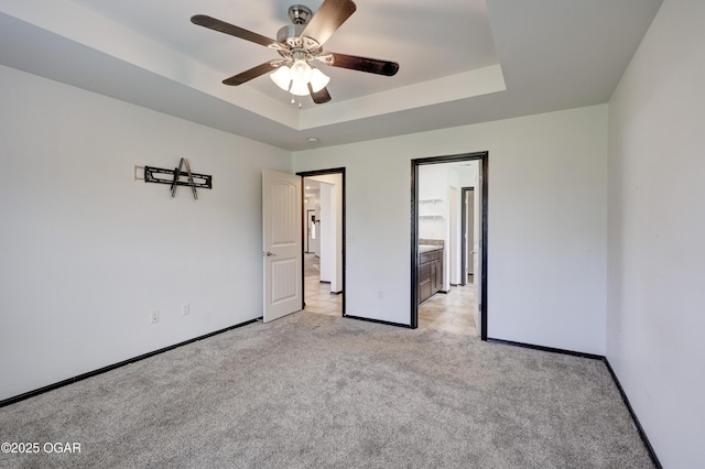 2036 S Ozark, Joplin, MO 64804 - unfurnished bedroom with light colored carpet, a raised ceiling, and ceiling fan