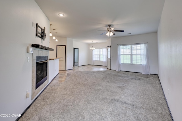2036 S Ozark, Joplin, MO 64804 - unfurnished living room featuring ceiling fan, light carpet, a fireplace, a chandelier, and recessed lighting