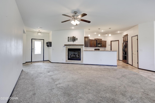 2036 S Ozark, Joplin, MO 64804 - unfurnished living room featuring ceiling fan, a tiled fireplace, recessed lighting, and light carpet