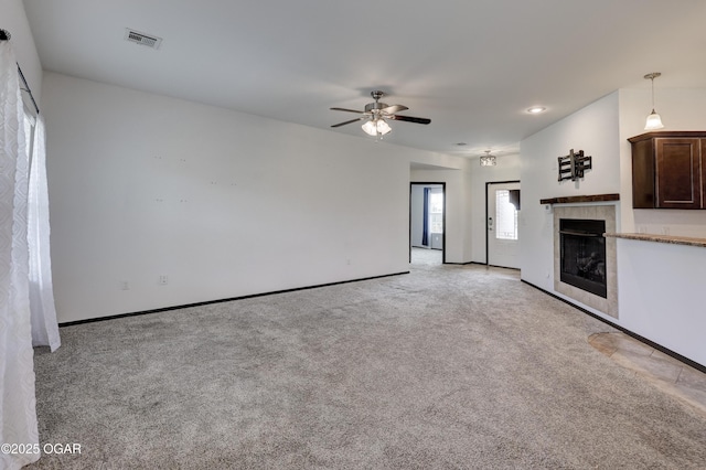 2036 S Ozark, Joplin, MO 64804 - unfurnished living room with ceiling fan, light colored carpet, and a tile fireplace