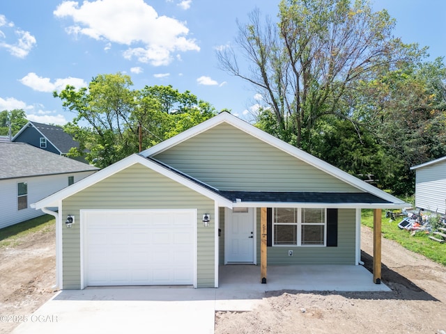 512 N Devon Ave, Webb City, MO 64870 - view of front of home featuring concrete driveway, an attached garage, and a porch