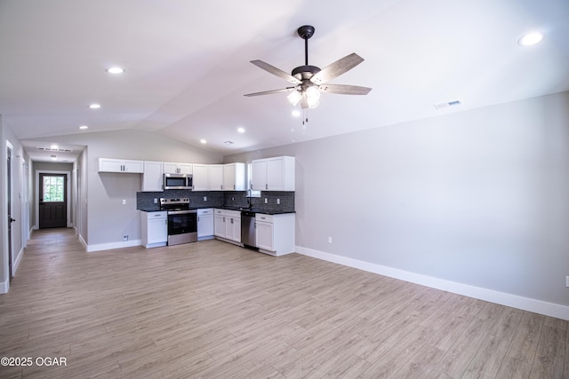 512 N Devon Ave, Webb City, MO 64870 - kitchen featuring stainless steel appliances, vaulted ceiling, a ceiling fan, white cabinetry, and dark countertops