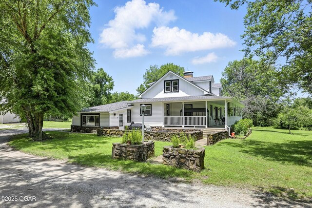 25327 Central Ave, Joplin, MO 64801 - view of front facade with a porch, a chimney, a front lawn, and a shingled roof