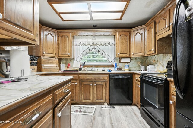 25327 Central Ave, Joplin, MO 64801 - kitchen featuring black appliances, light countertops, and decorative backsplash