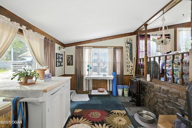 25327 Central Ave, Joplin, MO 64801 - living area featuring wainscoting, wood walls, and dark colored carpet