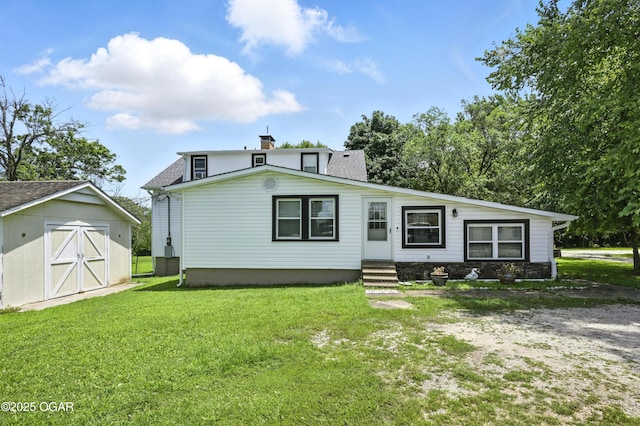 25327 Central Ave, Joplin, MO 64801 - view of front of house featuring entry steps, a storage shed, a front lawn, and a chimney