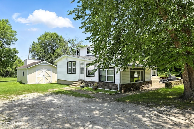 25327 Central Ave, Joplin, MO 64801 - view of front facade featuring entry steps, a storage unit, stone siding, and a front yard