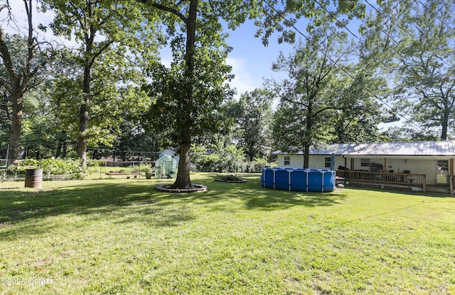 137 Lone Elm Dr, Carl Junction, MO 64834 - view of green lawn with a covered pool and a wooden deck