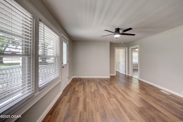 605 S Jefferson St, Webb City, MO 64870 - spare room with healthy amount of natural light, wood finished floors, and ceiling fan